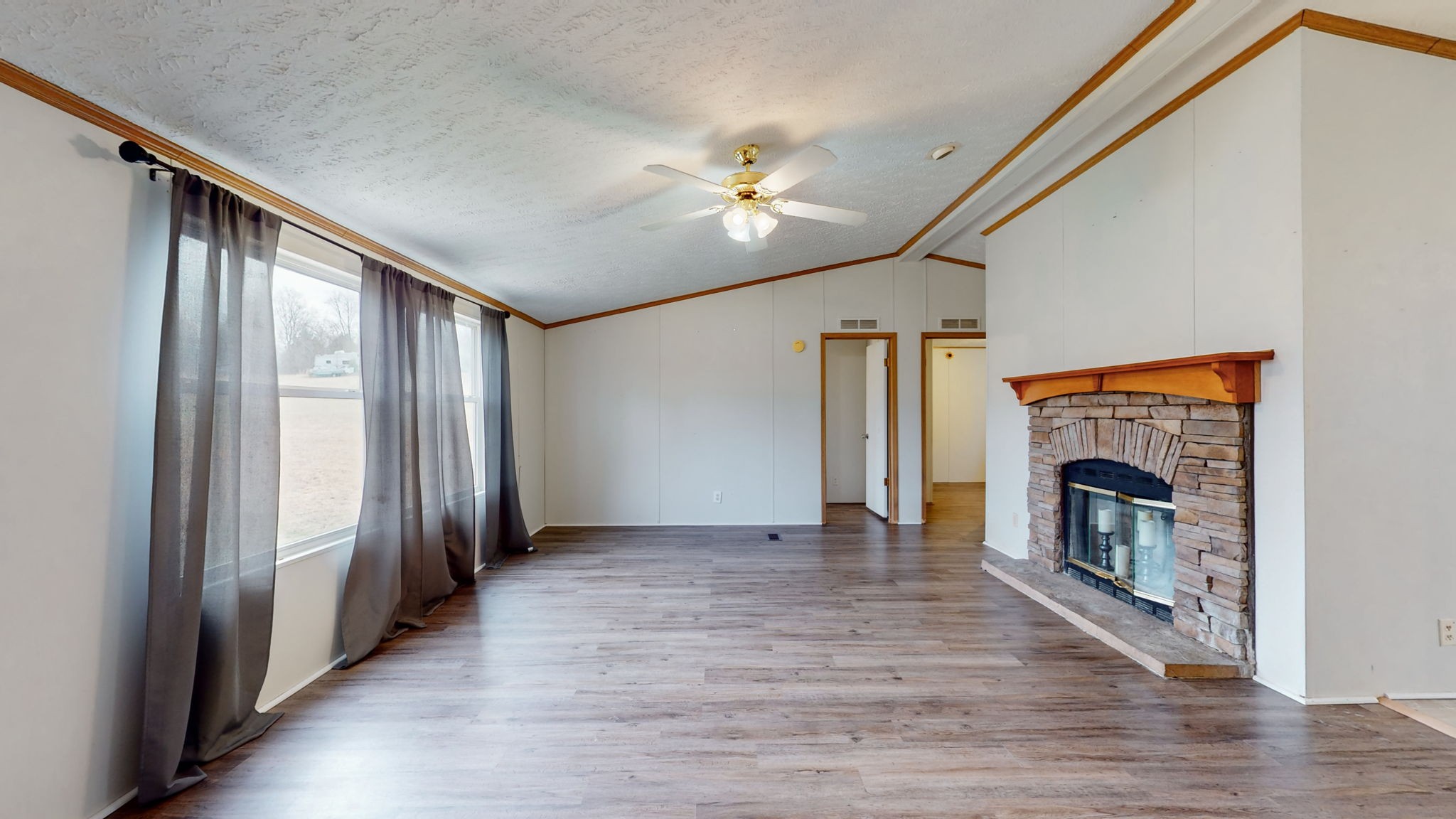 1118 Drake Road Clarksville, TN 37043 - Photo 5 of 38 a view of an empty room with wooden floor fireplace and a window