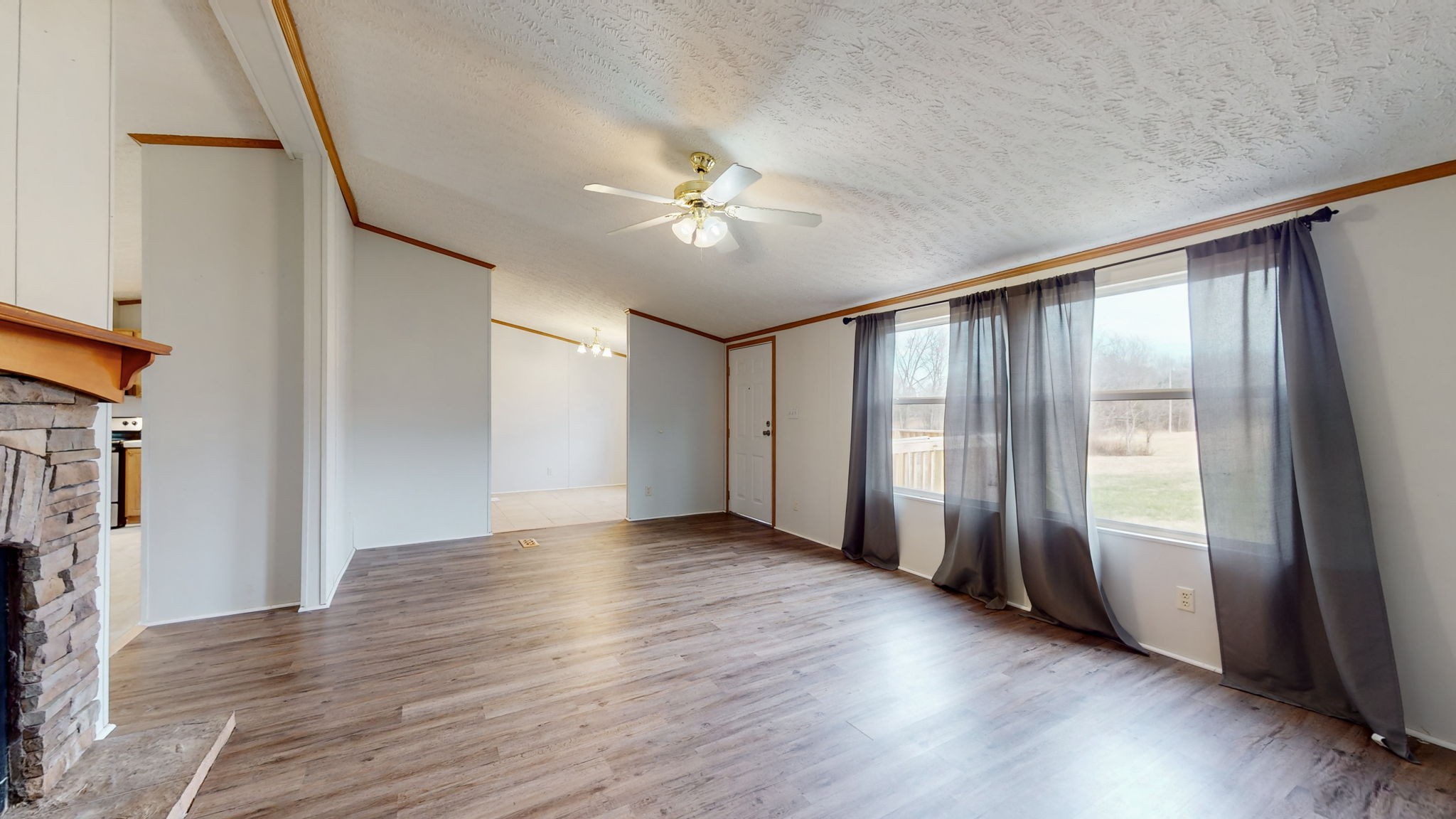 1118 Drake Road Clarksville, TN 37043 - Photo 8 of 38 a view of an empty room with a window and wooden floor