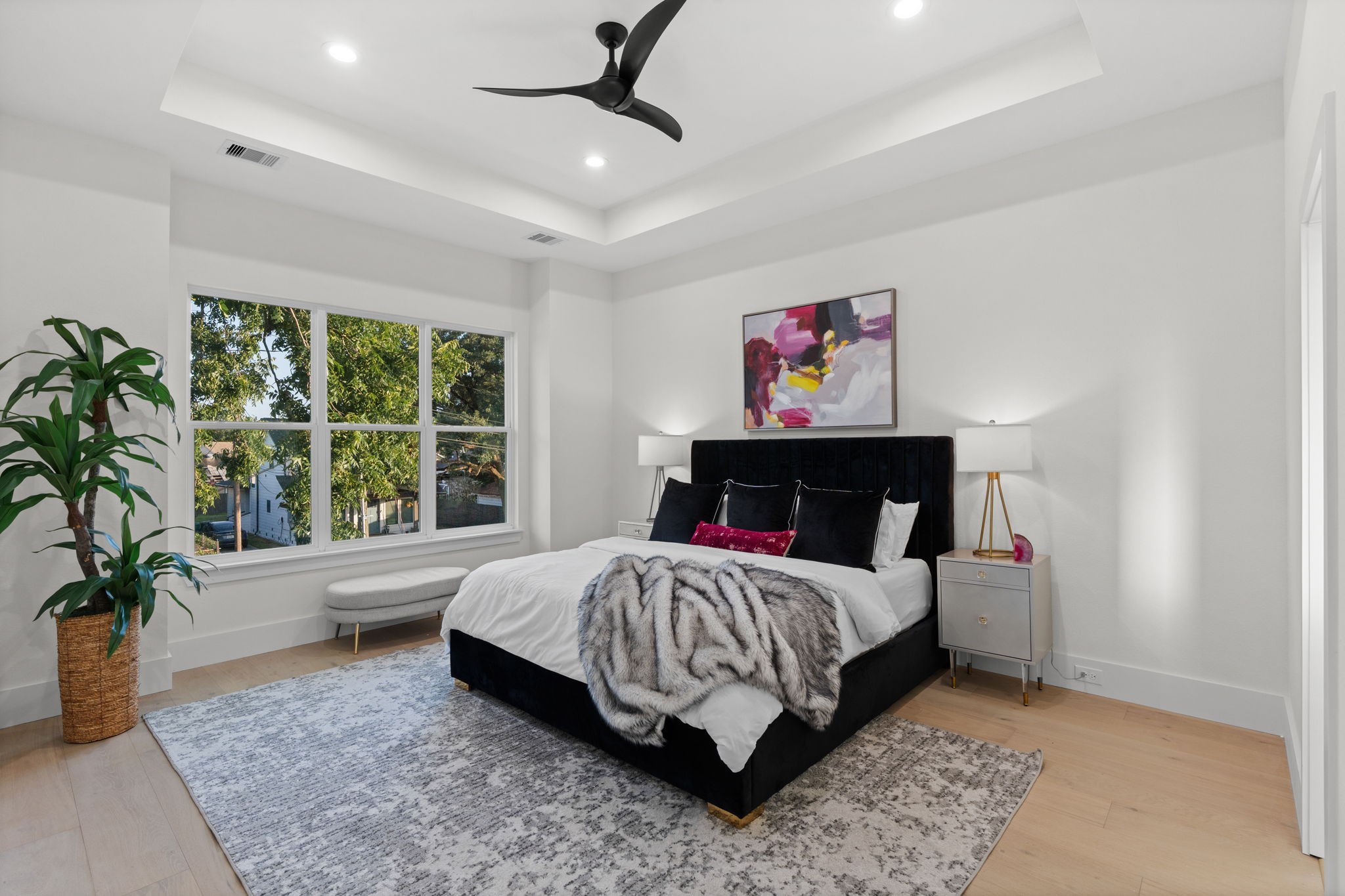 1622 Mable Street Houston, TX 77023 - Photo 14 of 25 a bedroom with a large bed and a potted plant