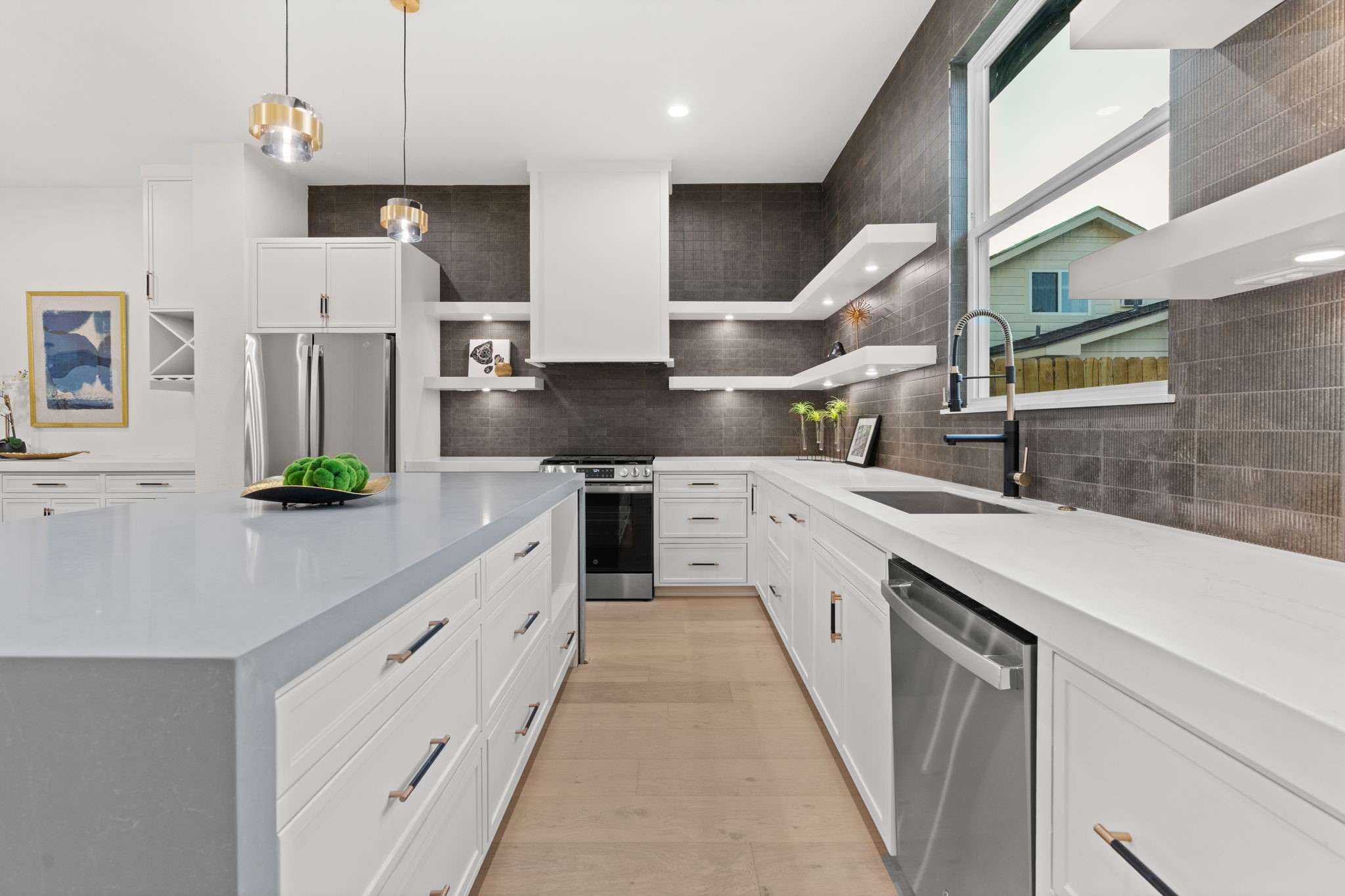 1622 Mable Street Houston, TX 77023 - Photo 9 of 25 a large kitchen with stainless steel appliances kitchen island granite countertop a sink a stove and cabinets