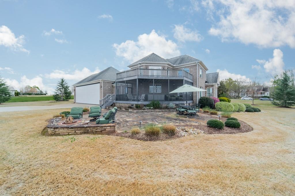 180 Chandelle Ridge Drive Woodruff, SC 29388 - Photo 18 of 48 a view of a house with backyard and sitting area