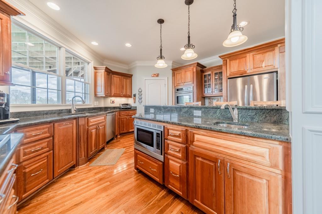 180 Chandelle Ridge Drive Woodruff, SC 29388 - Photo 23 of 48 a large kitchen with stainless steel appliances granite countertop a stove a sink and a granite counter tops
