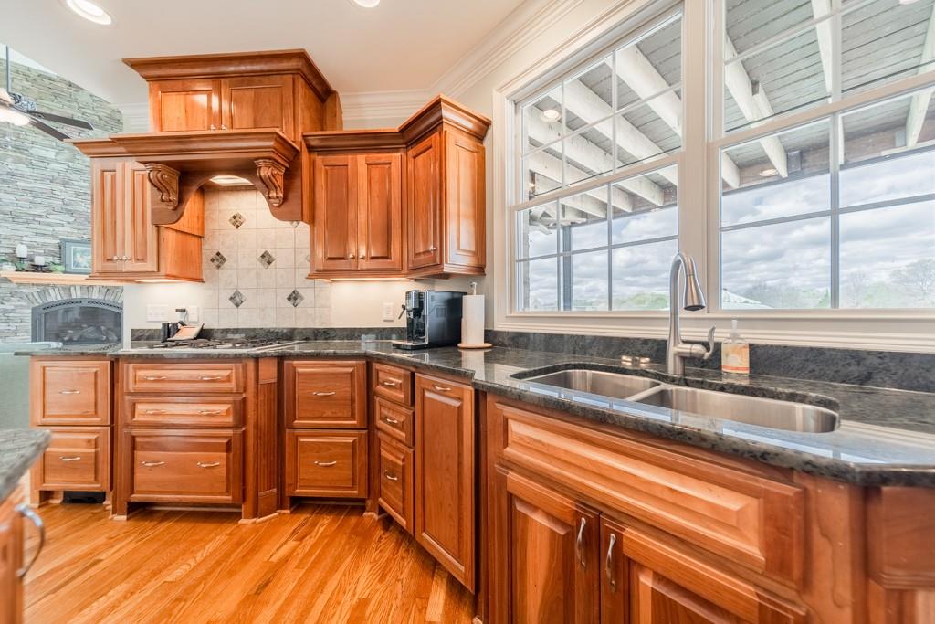180 Chandelle Ridge Drive Woodruff, SC 29388 - Photo 25 of 48 a kitchen with stainless steel appliances granite countertop a sink a stove and cabinets