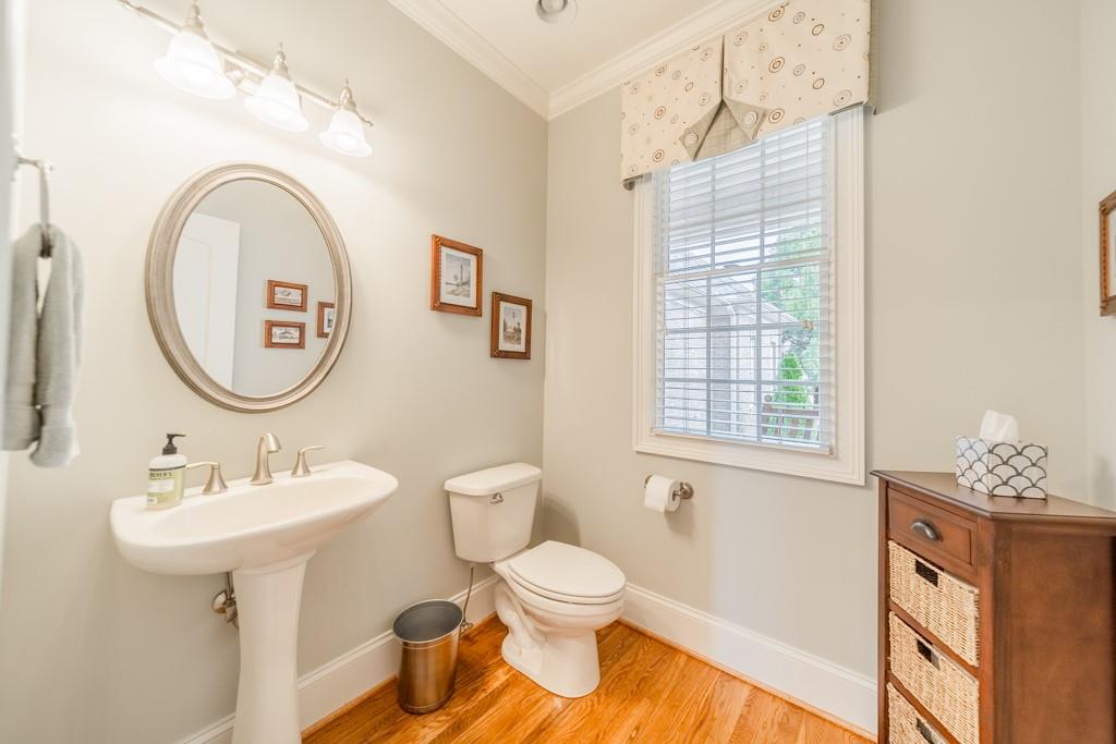 180 Chandelle Ridge Drive Woodruff, SC 29388 - Photo 36 of 48 a bathroom with a toilet a sink a mirror and a window
