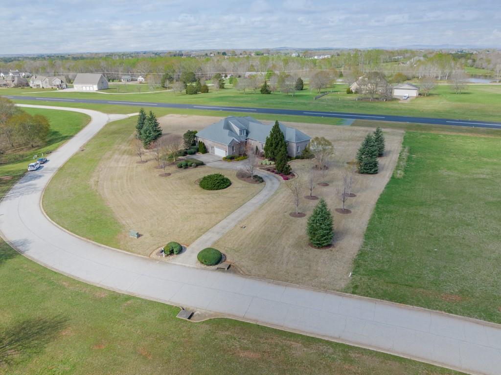 180 Chandelle Ridge Drive Woodruff, SC 29388 - Photo 8 of 48 an aerial view of a house with a yard and lake view