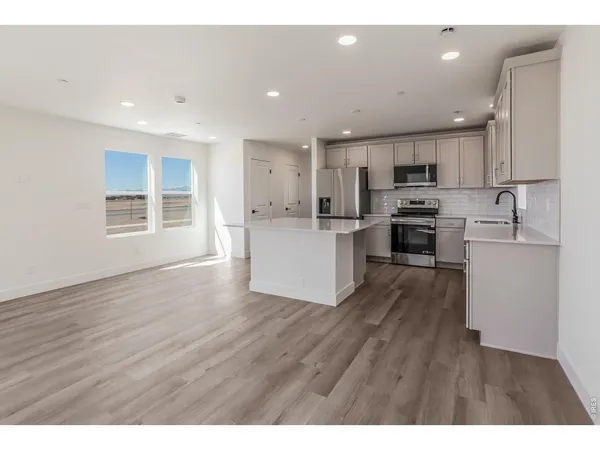 a bathroom with a granite countertop sink toilet a mirror and shower