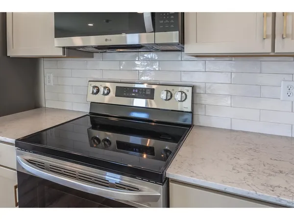a bathroom with a granite countertop sink toilet a mirror and shower