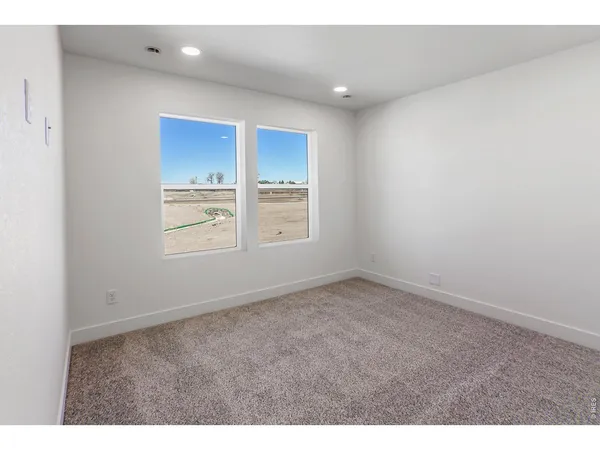 a kitchen with wooden floors and white cabinets
