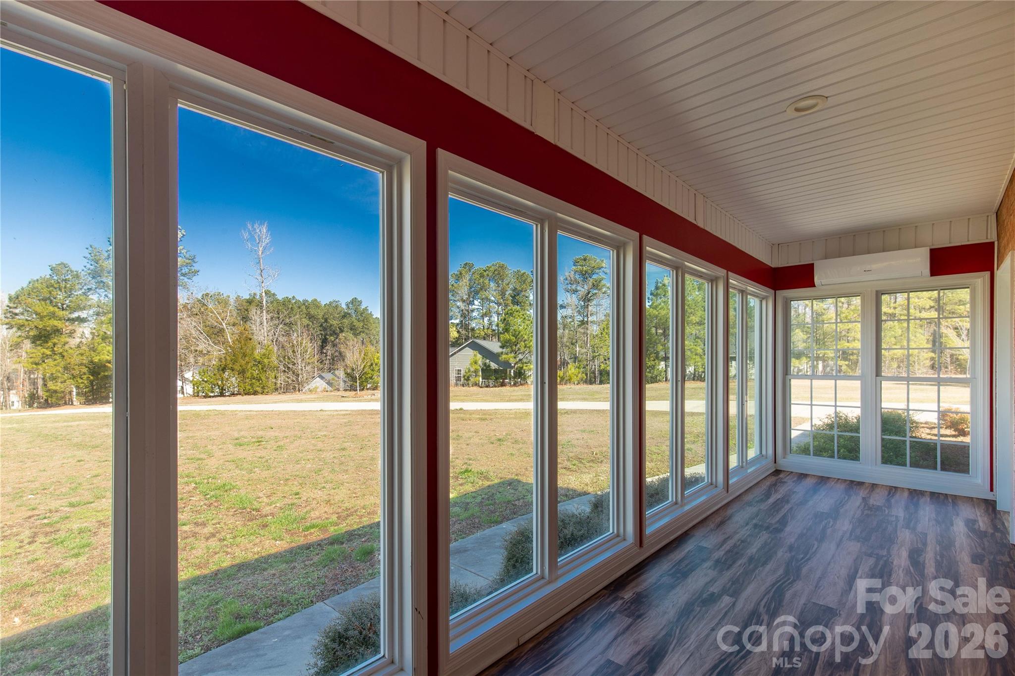 3034 Mulberry Lane Lancaster, SC 29720 - Photo 20 of 30 a view of an empty room with wooden floor and a large window