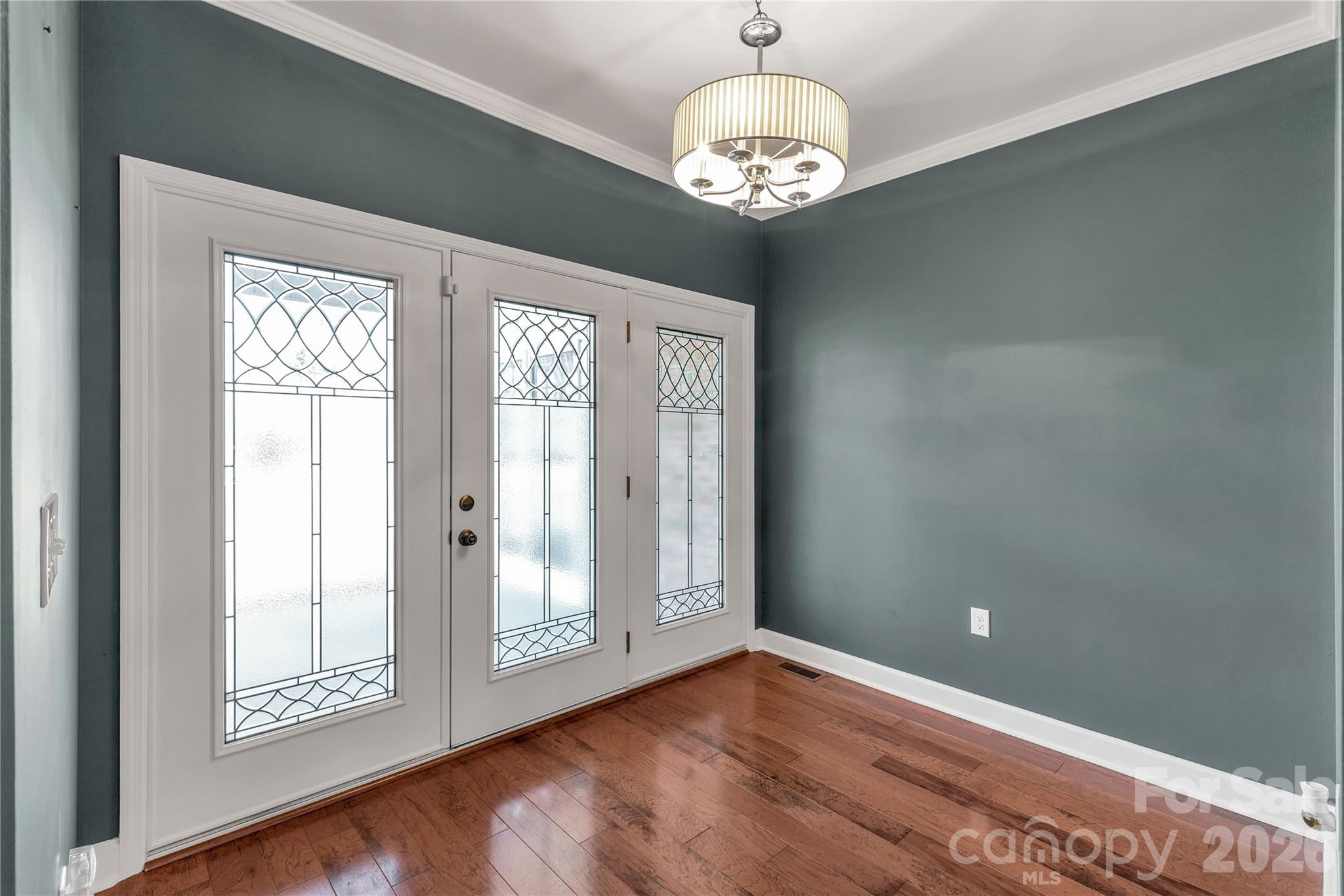 3034 Mulberry Lane Lancaster, SC 29720 - Photo 4 of 30 a view of an empty room with wooden floor and a window