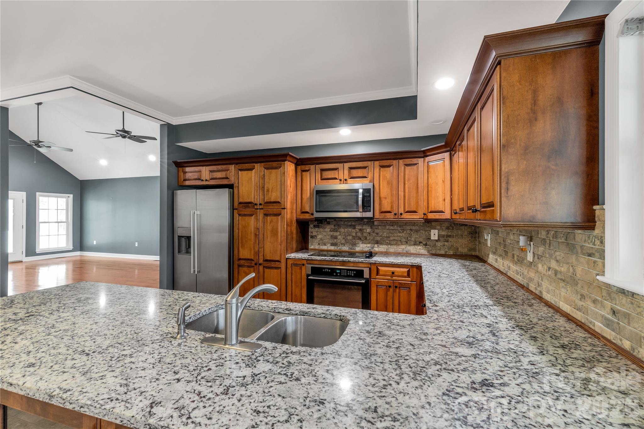 3034 Mulberry Lane Lancaster, SC 29720 - Photo 8 of 30 a kitchen with stainless steel appliances granite countertop a sink and a granite counter tops