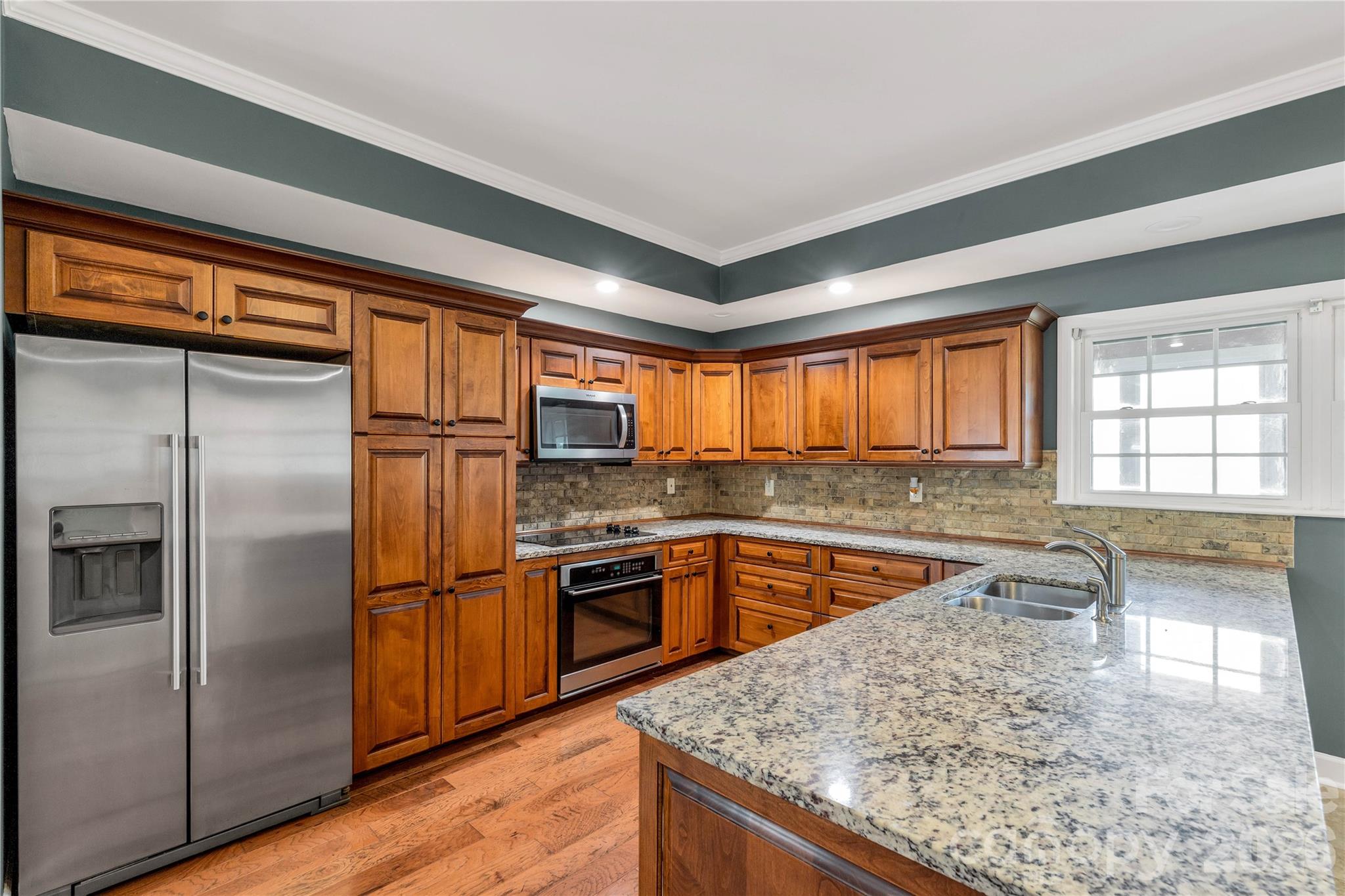 3034 Mulberry Lane Lancaster, SC 29720 - Photo 9 of 30 a kitchen with stainless steel appliances granite countertop a refrigerator a sink a stove and island