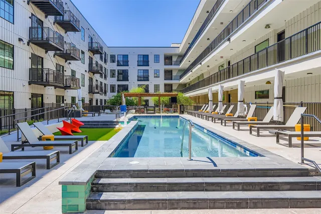 a view of a swimming pool with sitting area and seating area