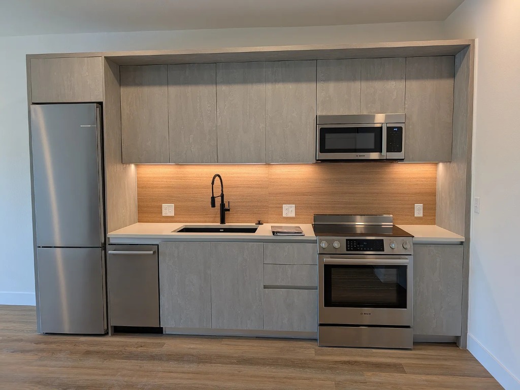 4315 South Congress Avenue, Unit 233 Austin, TX 78745 - Photo 3 of 25 a kitchen with stainless steel appliances a stove microwave and sink