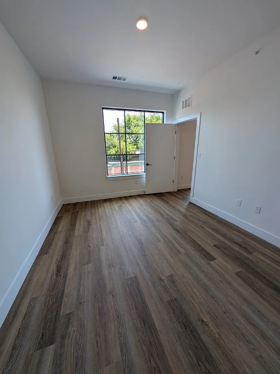 4315 South Congress Avenue, Unit 233 Austin, TX 78745 - Photo 6 of 25 an empty room with wooden floor and windows