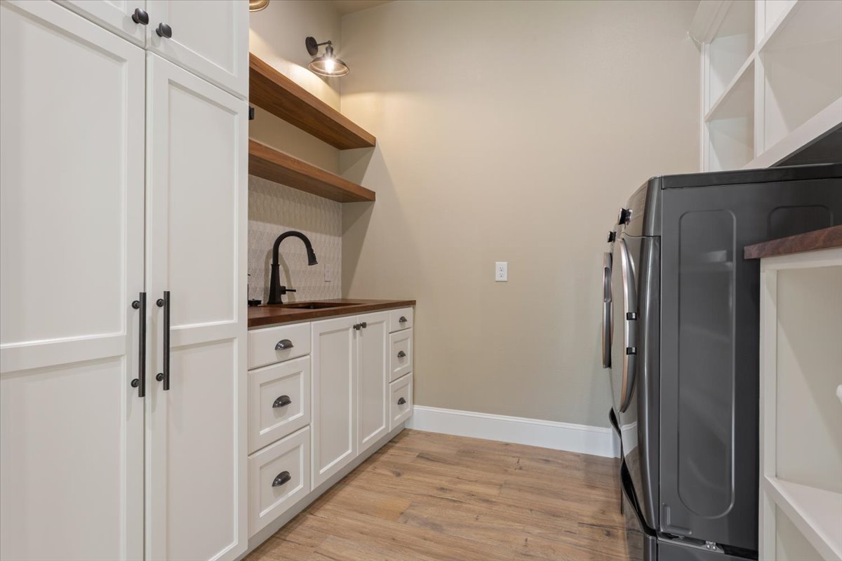 309 Highland Spring Lane Georgetown, TX 78633 - Photo 15 of 40 Once again, the Sellers thought of everything. On the right, washer & dryer hookups & cubby shelves galore...