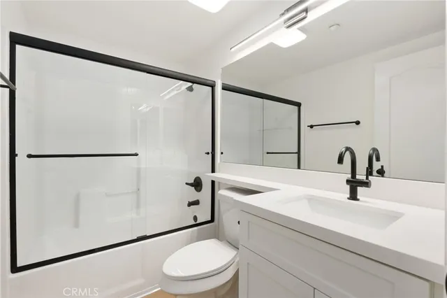 a living room with furniture kitchen view and a flat screen tv