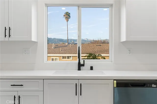 a view of kitchen with refrigerator dining table and chairs