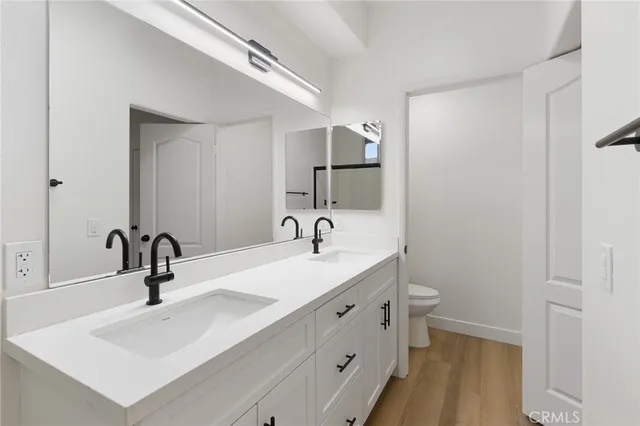 a bedroom with bed and wall painting