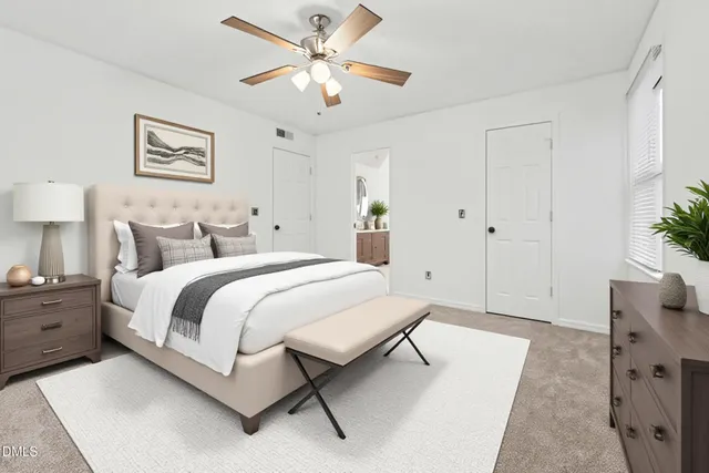 a spacious bedroom with a bed and a chandelier