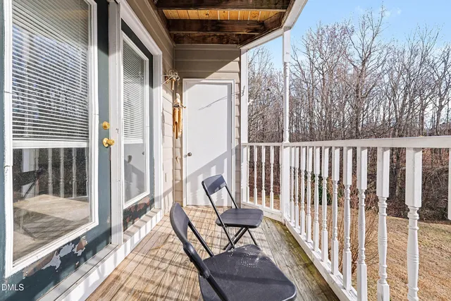a view of balcony with wooden floor and outdoor seating