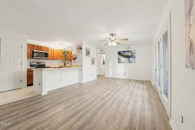 a view of a kitchen with a sink cabinets and wooden floor