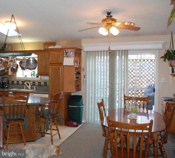 657 Running Fox Road Lusby, MD 20657 - Photo 6 of 16 dining off kitchen leads to private deck