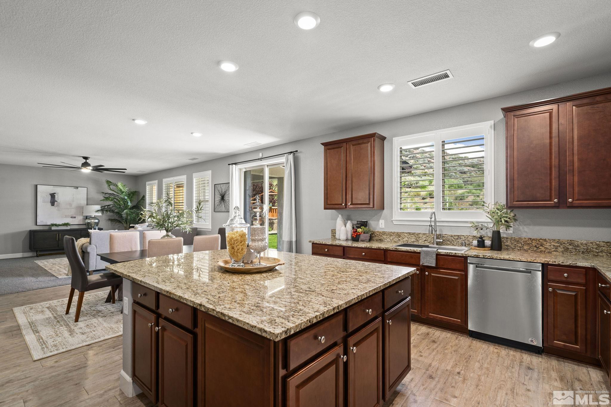 1820 Scott Valley Road Reno, NV 89523 - Photo 12 of 35 a kitchen with granite countertop sink stove and dining table