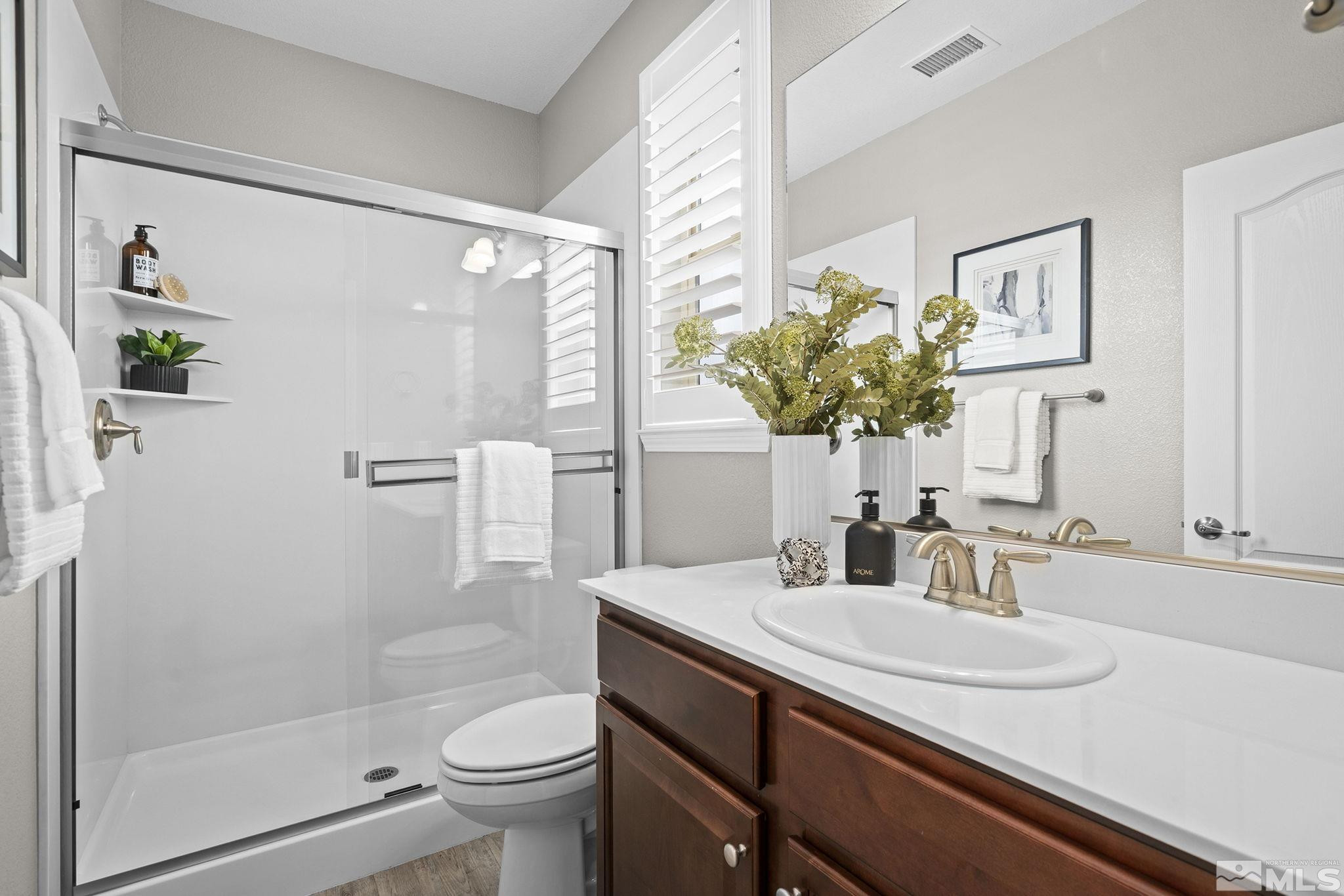 1820 Scott Valley Road Reno, NV 89523 - Photo 23 of 35 a bathroom with a granite countertop sink a toilet and shower