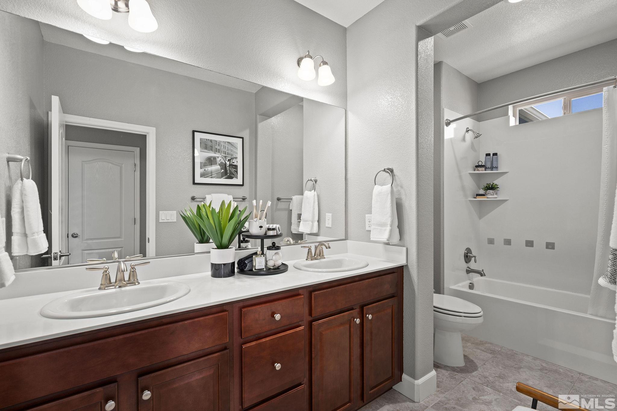 1820 Scott Valley Road Reno, NV 89523 - Photo 27 of 35 a bathroom with a granite countertop sink toilet and shower