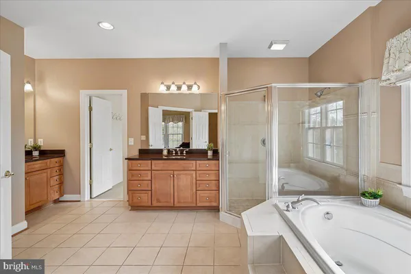 a spacious bedroom with a bed and a ceiling fan