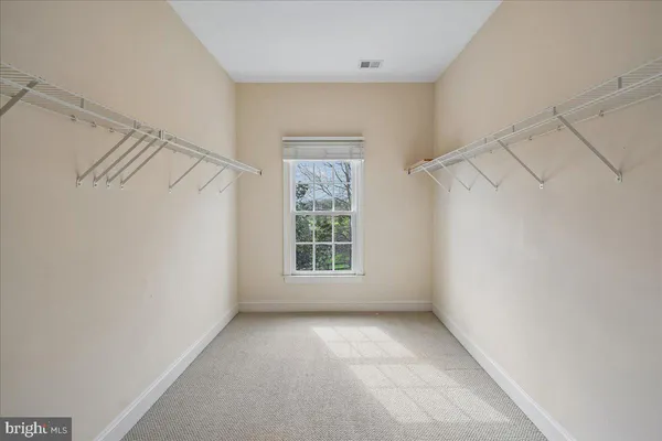 a bathroom with a granite countertop sink toilet mirror and shower
