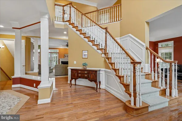 a view of entryway and hall with wooden floor