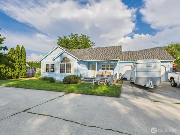 a view of a house with a yard and pathway