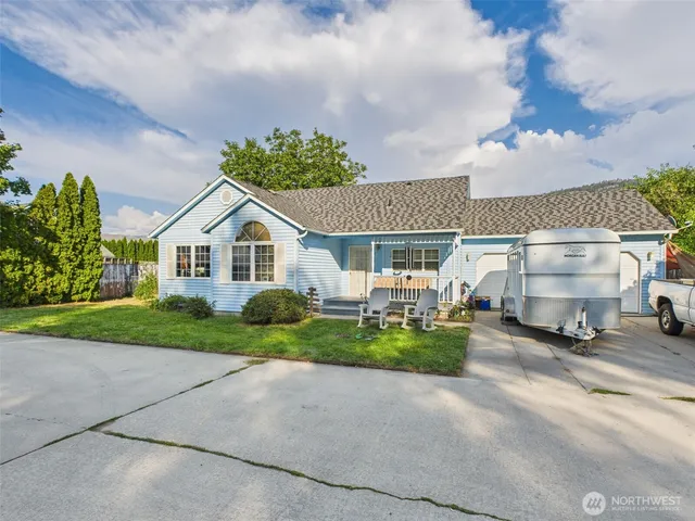 a view of a house with a yard and pathway