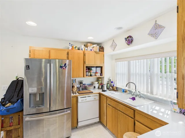 a kitchen with a refrigerator and a sink