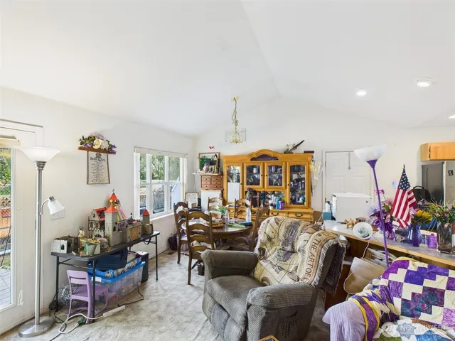 a living room with furniture fireplace and a chandelier