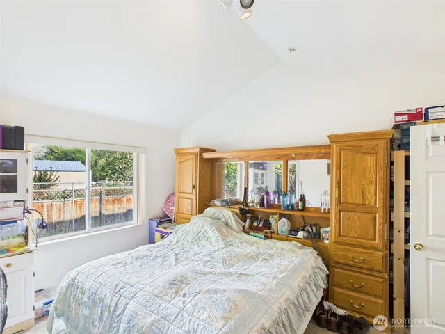 a bedroom with a large bed and a large window