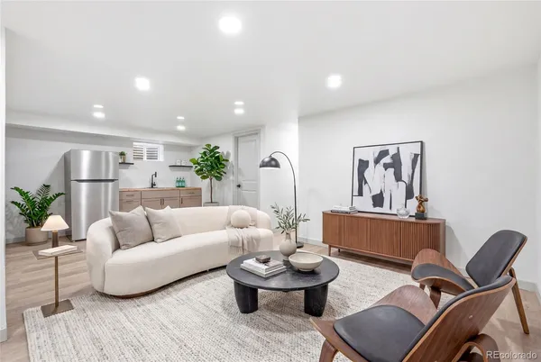 a living room with furniture and wooden floor