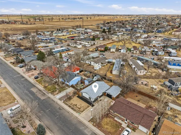 an aerial view of a residential houses with city view