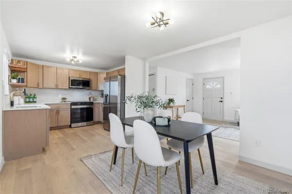 a view of a dining room with furniture and a kitchen