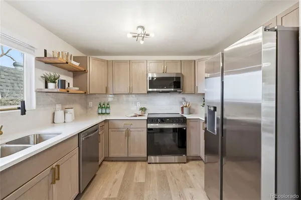 a kitchen with a sink stainless steel appliances and counter space