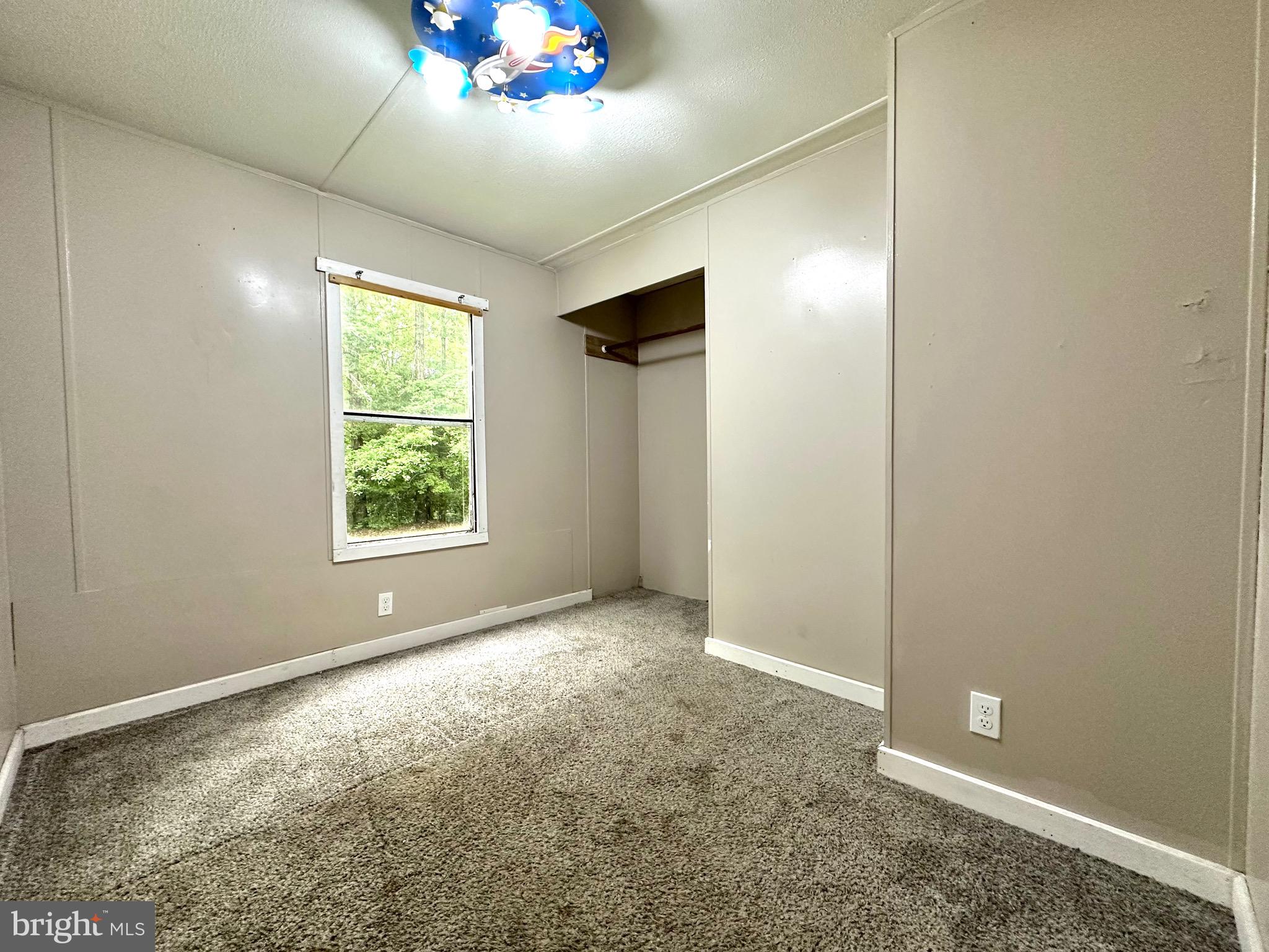 606 Dogwood Acres Road Bumpass, VA 23024 - Photo 8 of 20 an empty room with windows and closet