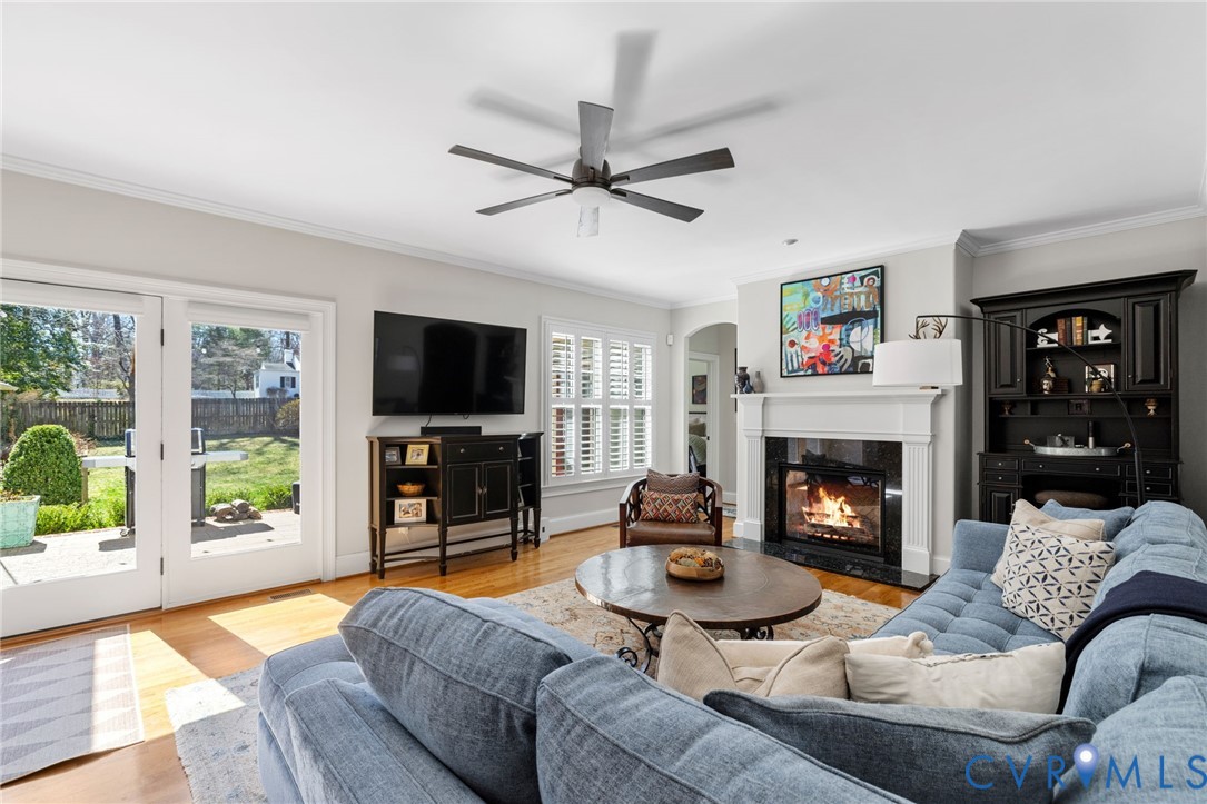 8947 Cherokee Road Richmond, VA 23235 - Photo 21 of 45 a living room with furniture a flat screen tv and a fireplace