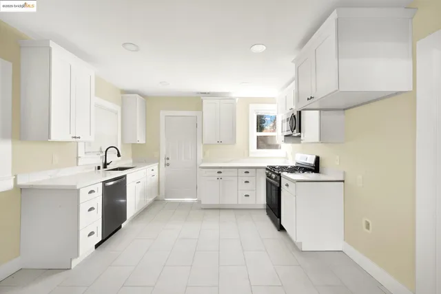 a large white kitchen with cabinets and white appliances