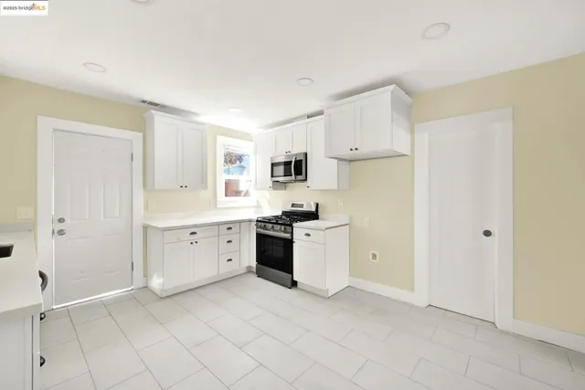 a large white kitchen with white cabinets