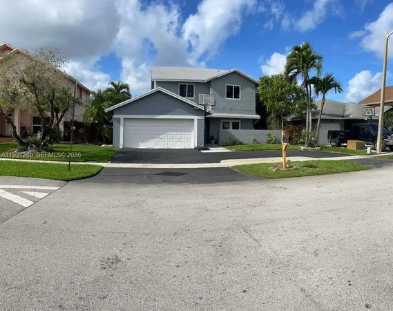 a front view of a house with a yard and a garage