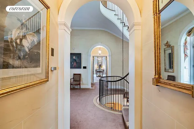 a view of staircase with fireplace and a potted plant