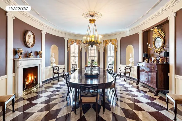 a living room with furniture a fireplace and a chandelier