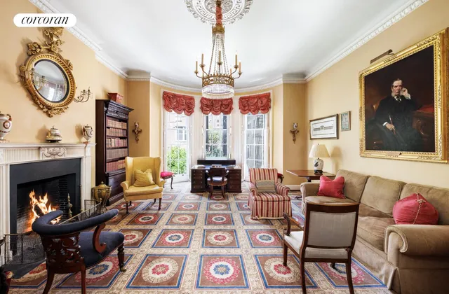a living room with fireplace furniture and a large window